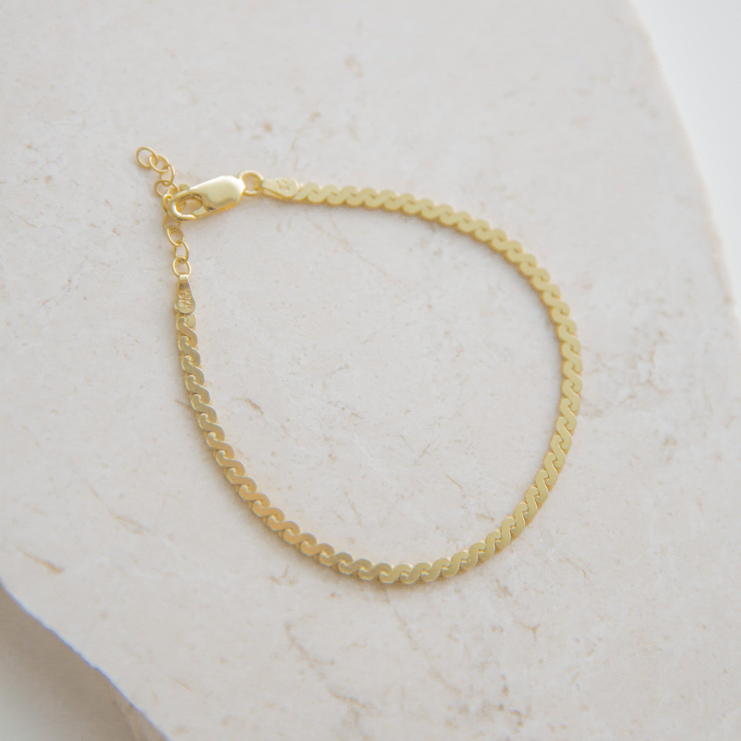 The Cashmere Bracelet in 14k Gold Filled, featuring a delicate 3mm chain with an adjustable extender.
