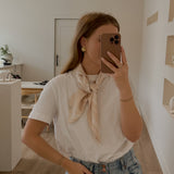 Fashion silky scarf by L&G in 65cm square design for stylish layering and accessorizing wear by a model